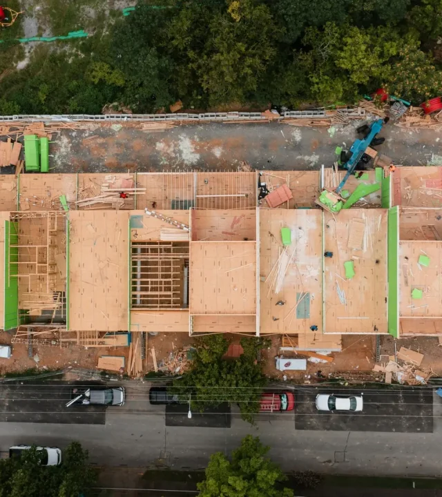 Aerial shot of a construction site in Chattanooga, showcasing wooden framework and heavy machinery.